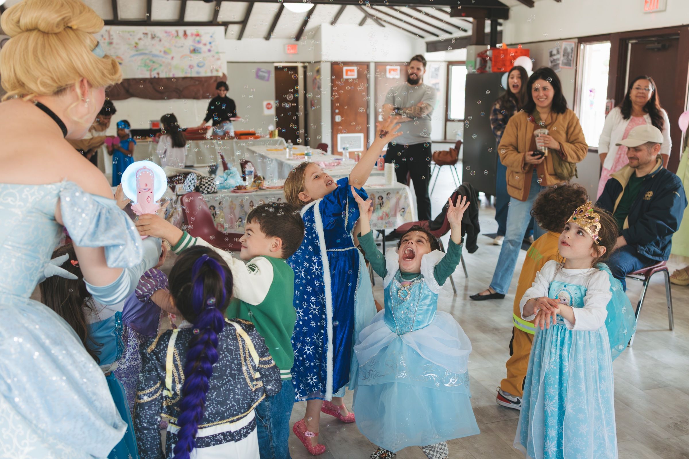 Princess-themed children's birthday party with bubbles and costumes