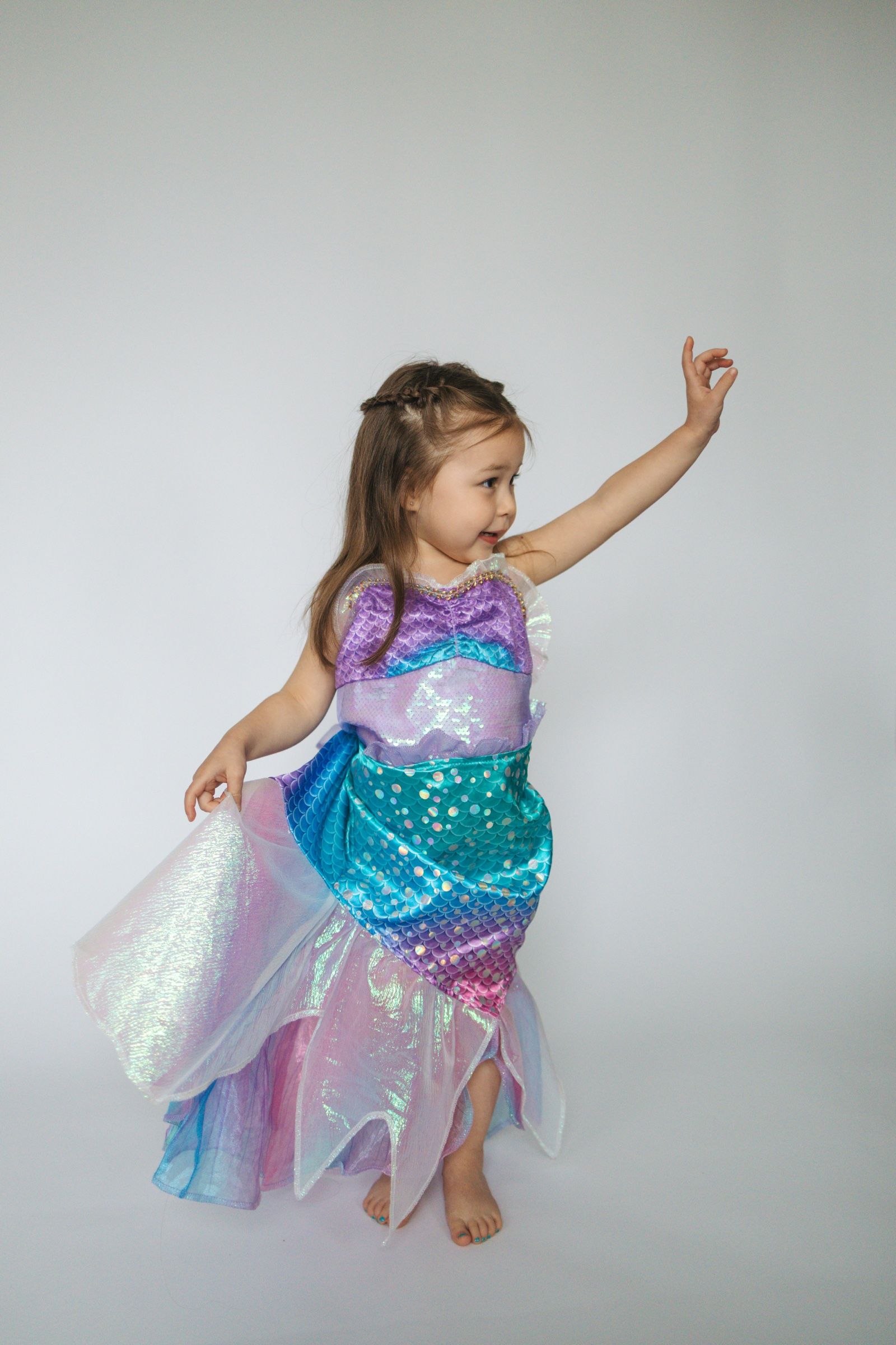 Young girl posing in a sparkling mermaid costume