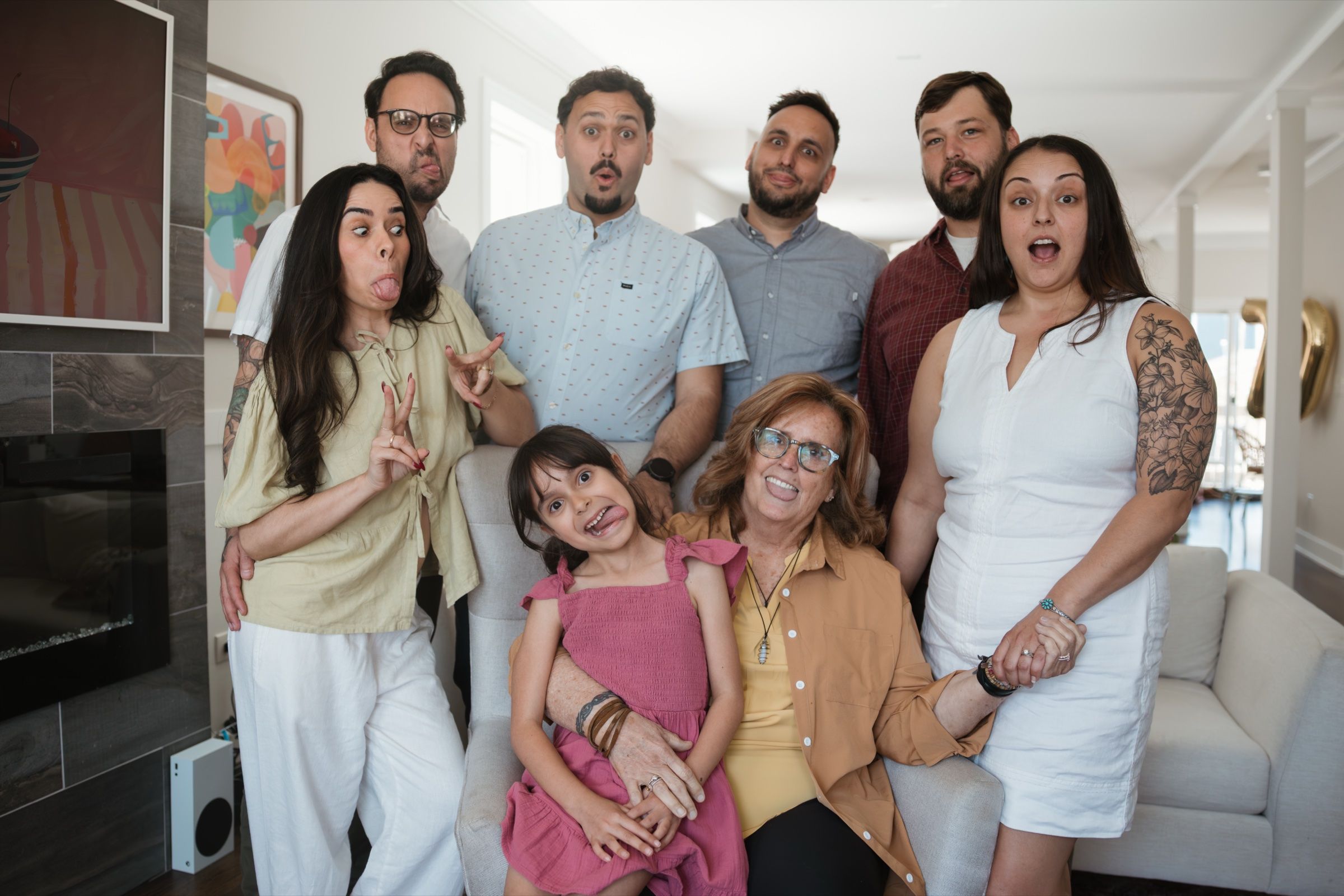 Multi-generational family making playful, silly faces together